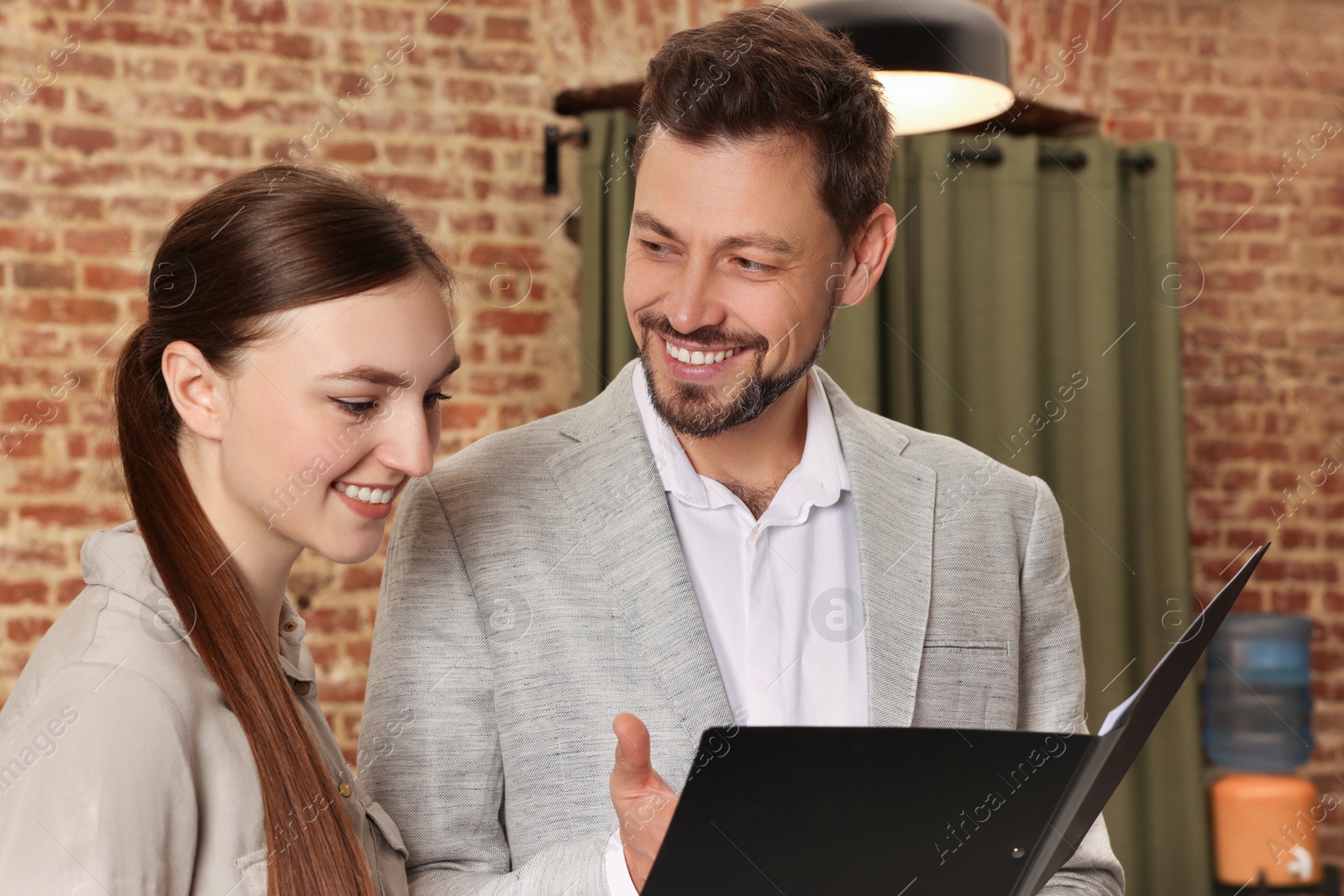 Photo of Team of employees working together in office