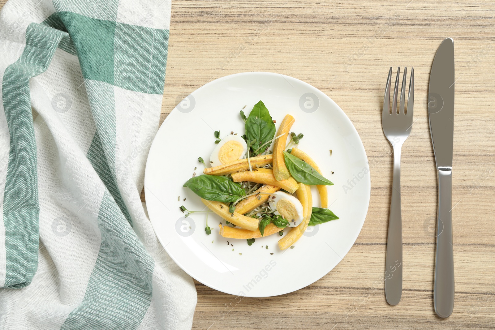 Photo of Delicious fresh carrot salad served on wooden table, flat lay