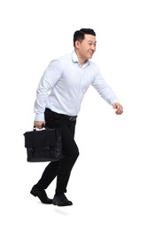 Businessman with briefcase running on white background