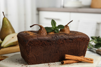 Photo of Tasty pear bread with mint and cinnamon on table. Homemade cake