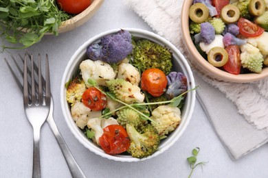 Photo of Delicious salad with cauliflower and tomato served on white table, flat lay