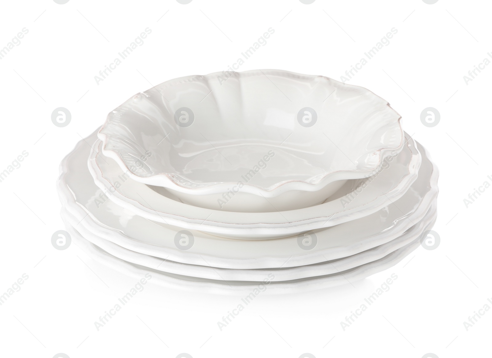 Photo of Stack of empty ceramic dishware on white background