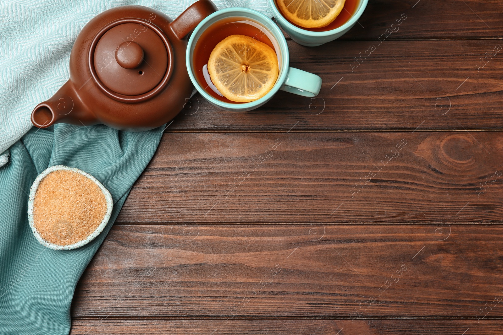 Photo of Flat lay composition with tea set on wooden background. Space for text