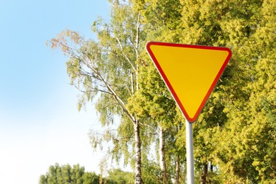 Traffic sign Yield outdoors on sunny day, space for text