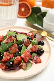 Delicious salad with sicilian orange on white table, closeup