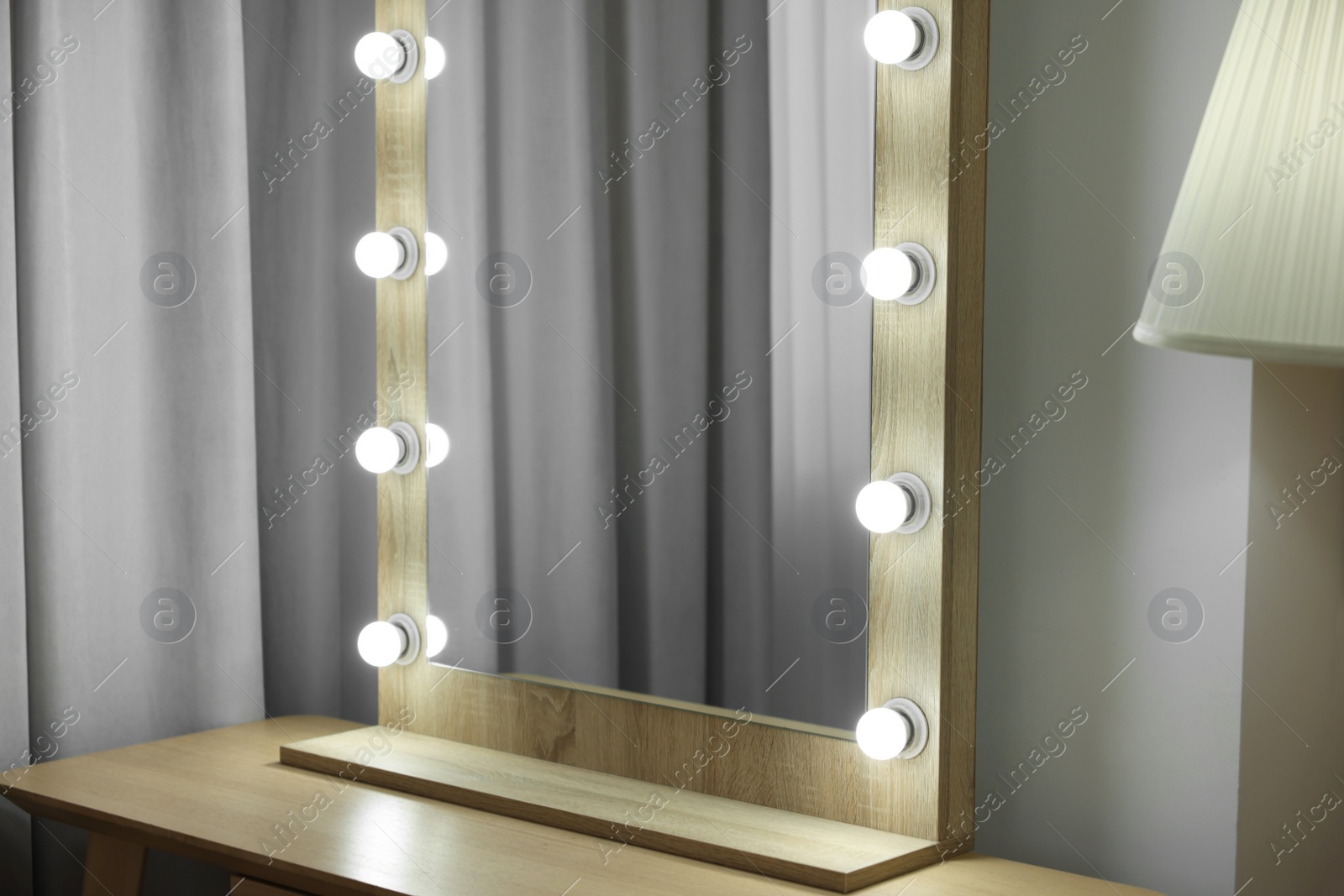 Photo of Beautiful mirror with light bulbs in makeup room