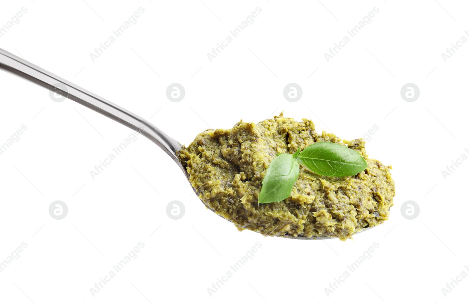 Photo of Spoon with delicious pesto sauce and basil isolated on white