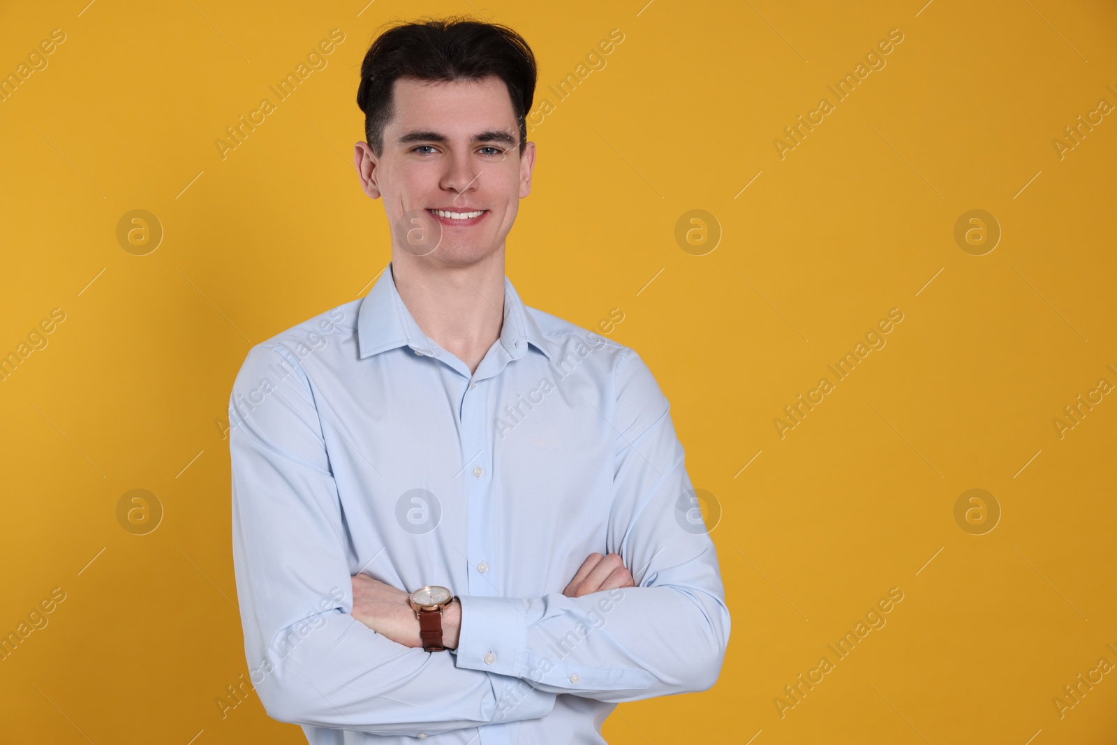 Photo of Portrait of happy young man on yellow background, space for text