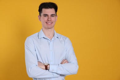 Photo of Portrait of happy young man on yellow background, space for text