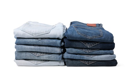 Image of Stacks of different folded jeans isolated on white