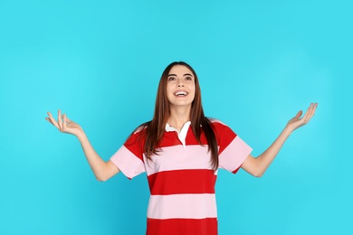 Photo of Portrait of emotional young woman on color background