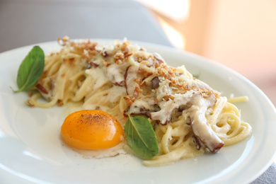 Photo of Delicious Carbonara pasta on plate, closeup view