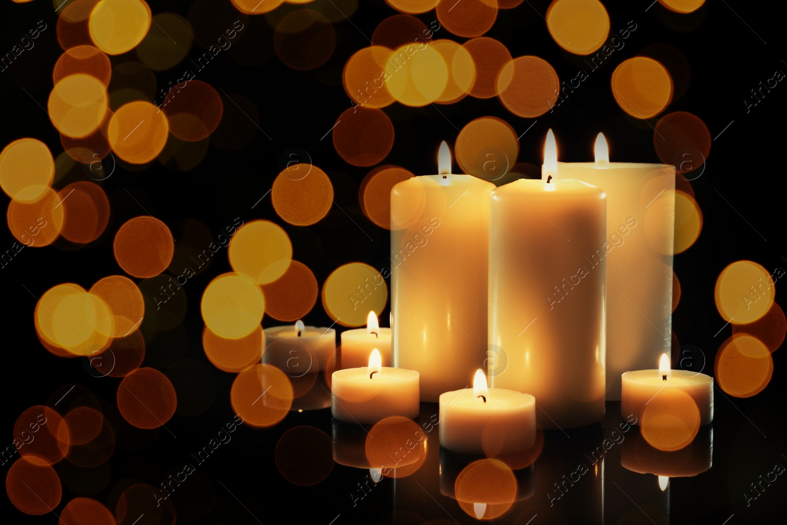 Image of Burning candles on dark background, bokeh effect