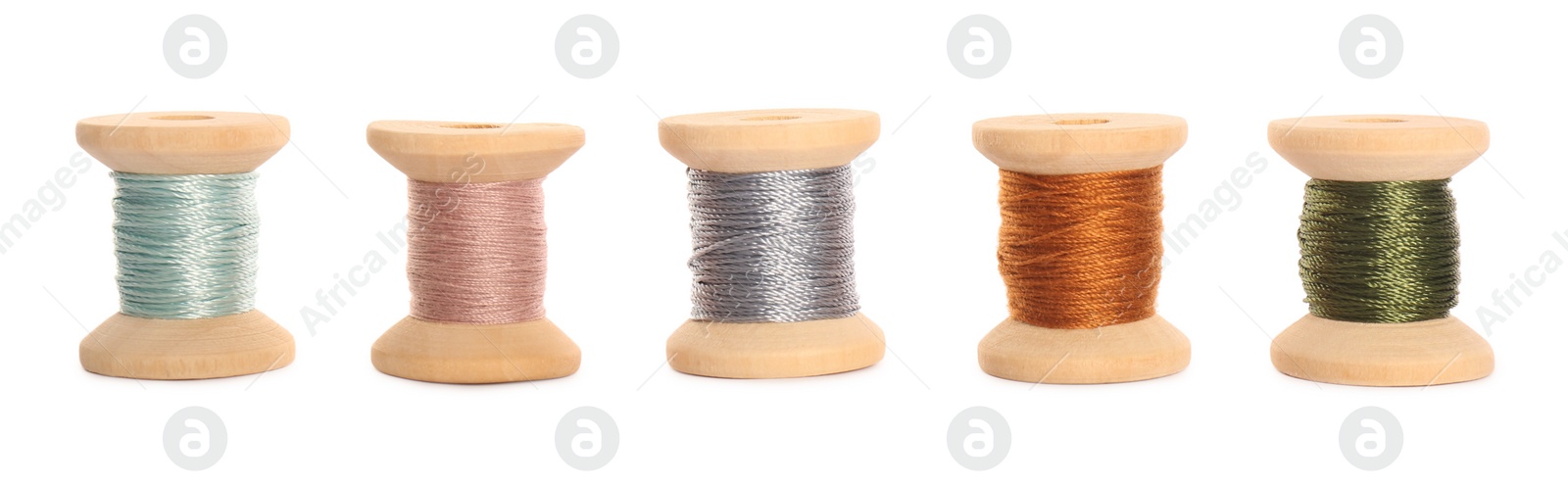 Photo of Set of colorful sewing threads on white background