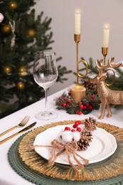 Luxury festive place setting with beautiful decor for Christmas dinner on white table indoors