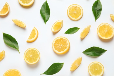 Fresh lemons and leaves on white background, top view. Citrus fruits