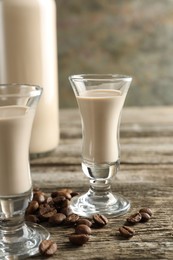 Coffee cream liqueur in glasses and beans on wooden table