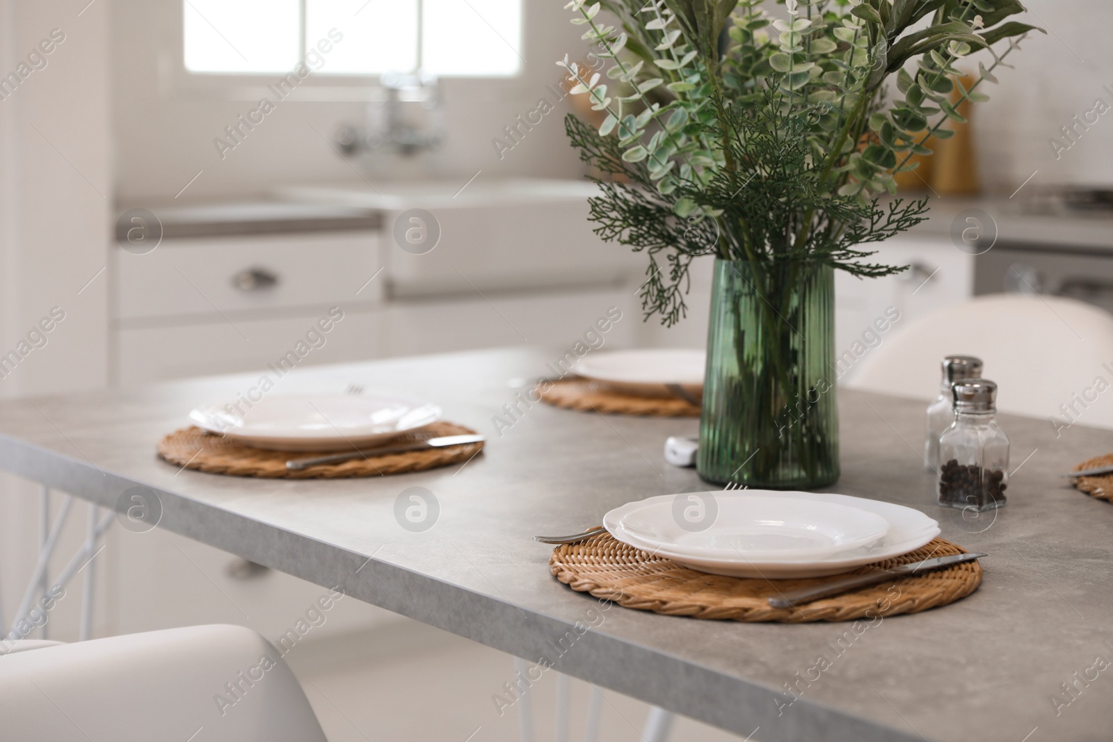 Photo of Elegant table setting with ceramic plates in kitchen. Interior design