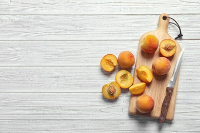 Photo of Flat lay composition with ripe peaches on wooden background