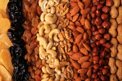 Photo of Mix of delicious dried nuts and fruits as background, top view