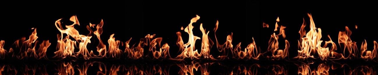 Image of Bright fire flames on black background. Banner design