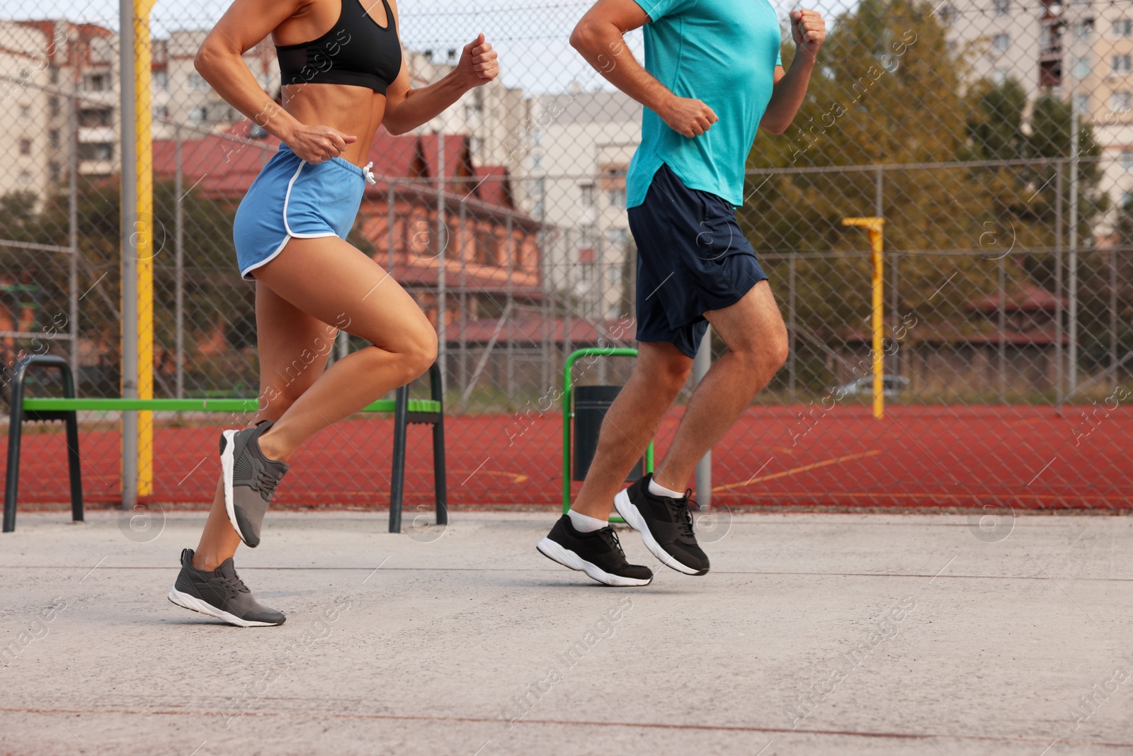 Photo of Healthy lifestyle. Sporty couple running outdoors, closeup