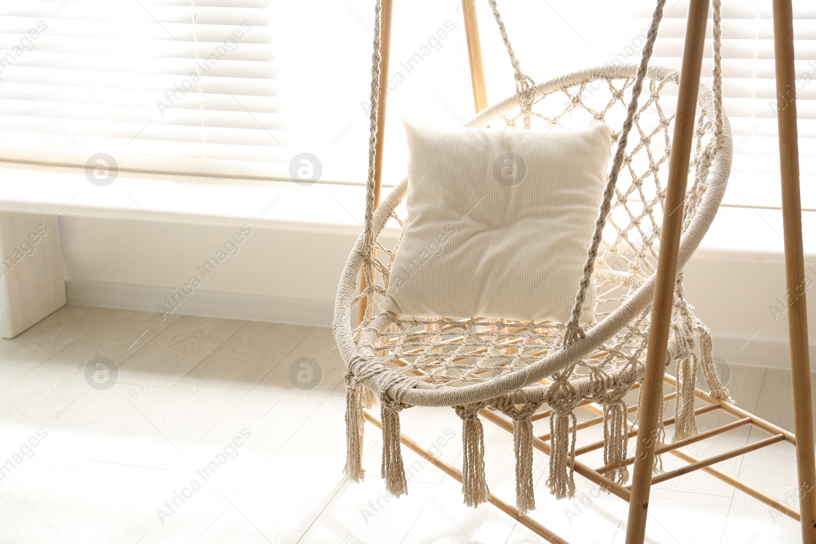 Photo of Comfortable hammock chair in stylish room. Home interior