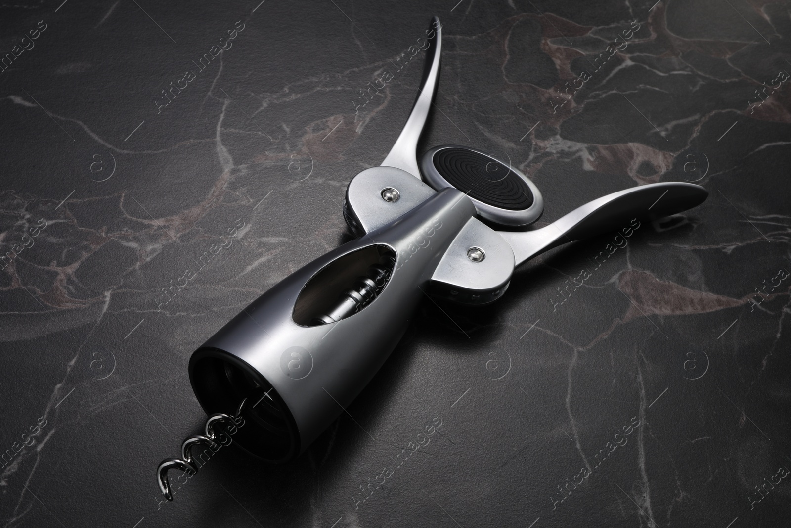 Photo of One wing corkscrew on black marble table