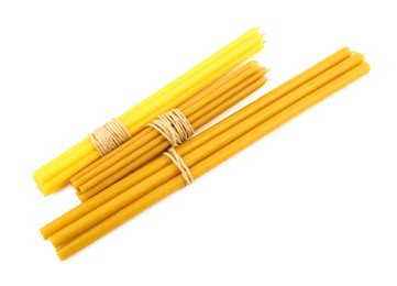 Bunches of church candles on white background, top view