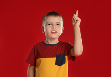 Photo of Portrait of little boy on red background