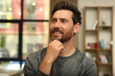 Photo of Portrait of handsome stylish man in office