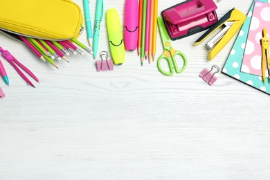 Photo of Flat lay composition with different school stationery on wooden background