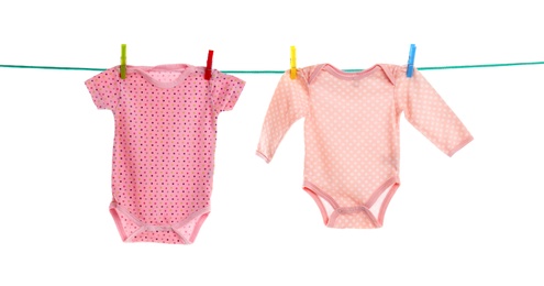 Photo of Baby clothes on laundry line against white background