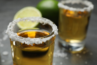 Mexican Tequila shots, with salt on grey table, closeup