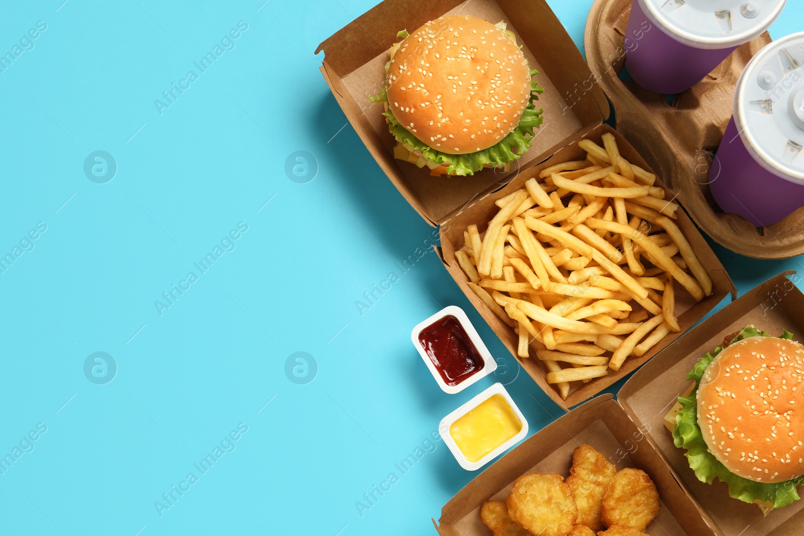Photo of Flat lay composition with delicious fast food menu on light blue background. Space for text