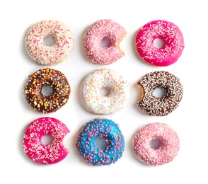 Photo of Delicious doughnuts with sprinkles on light background, top view