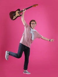 Photo of Young man with electric guitar on color background