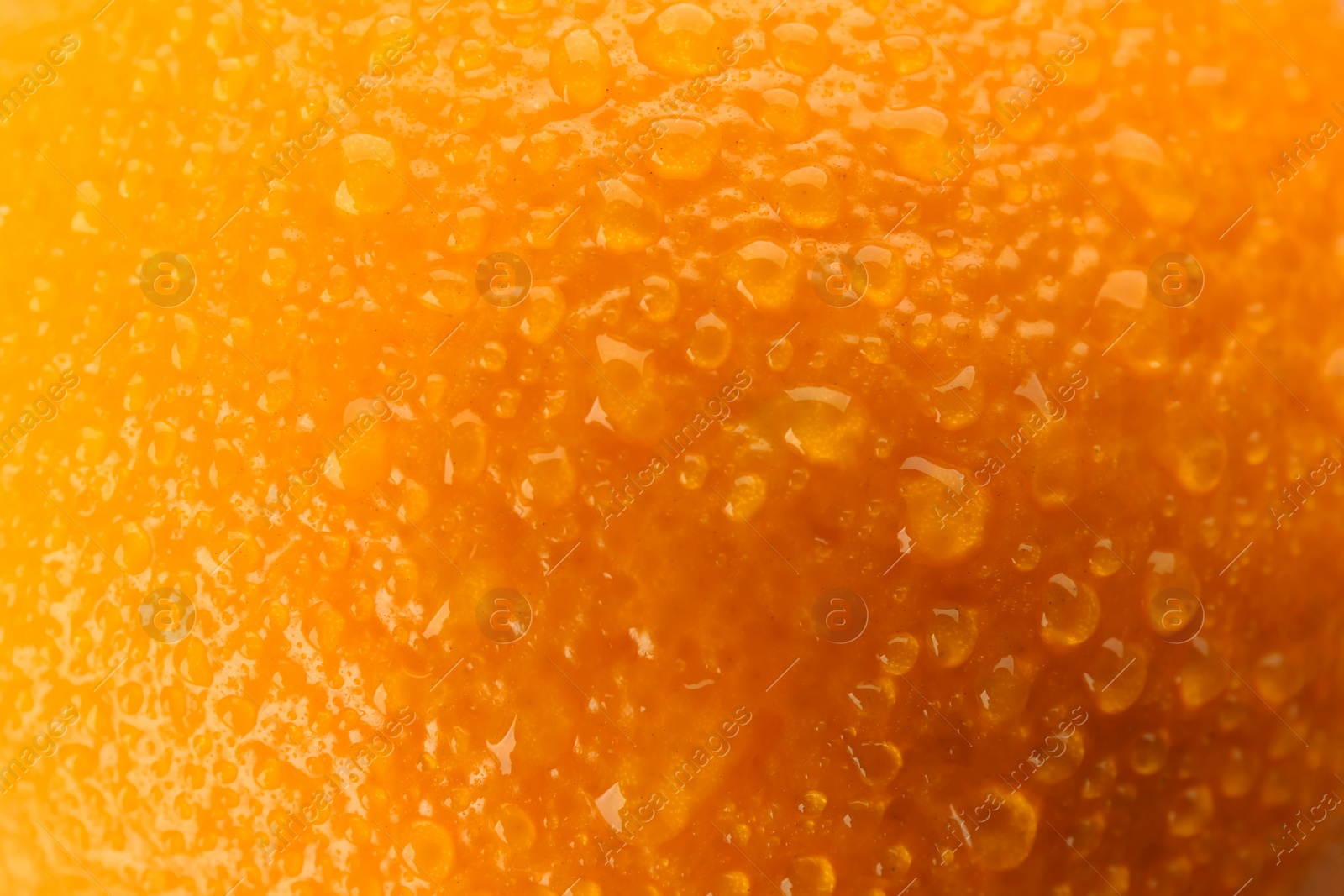 Photo of Delicious unpeeled orange with water drops as background, closeup