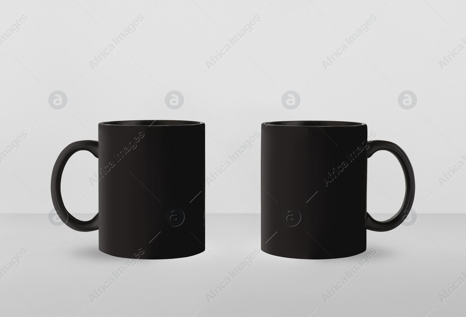 Image of Black ceramic mugs on white background. Mockup for design