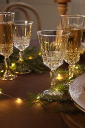 Photo of Christmas celebration. Glasses and festive decor on table