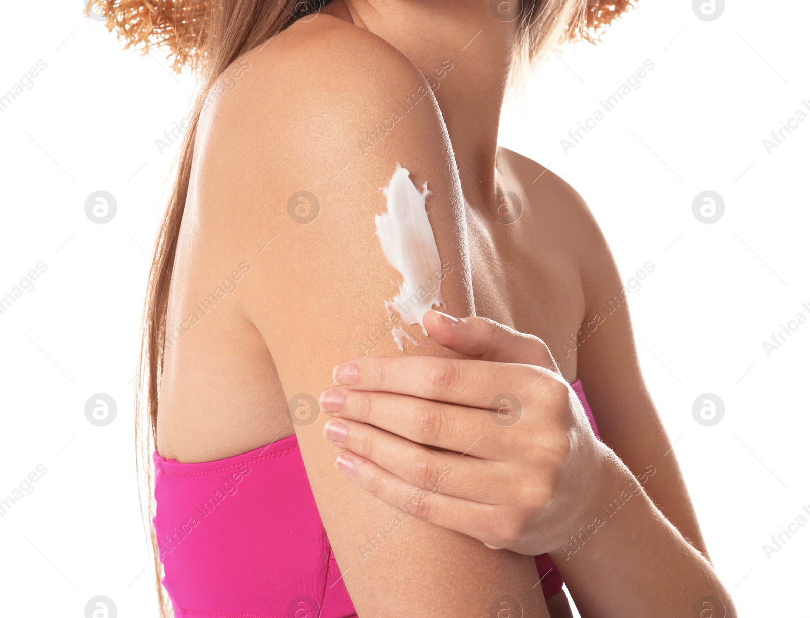 Photo of Woman applying sun protection cream on body against white background, closeup