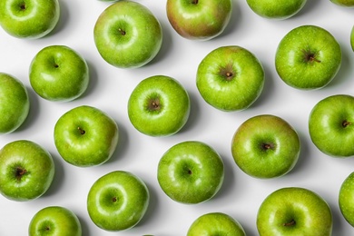 Many green apples on white background, top view