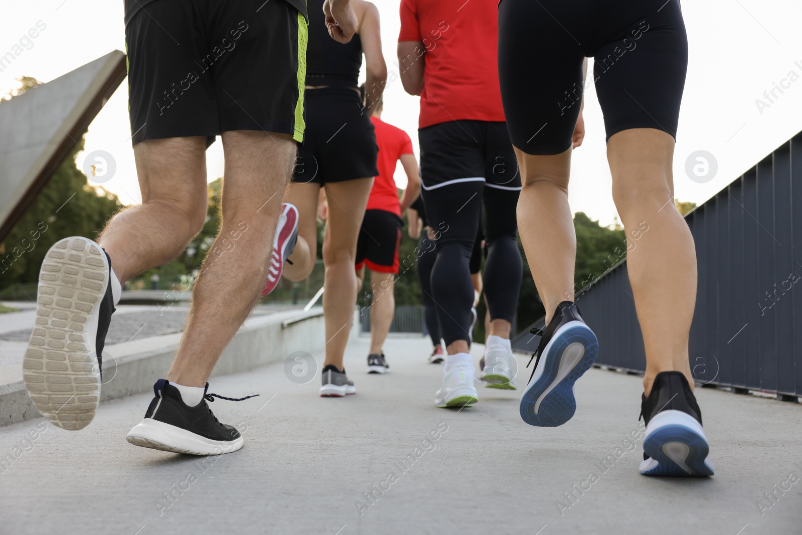 Photo of Group of people running outdoors, closeup view