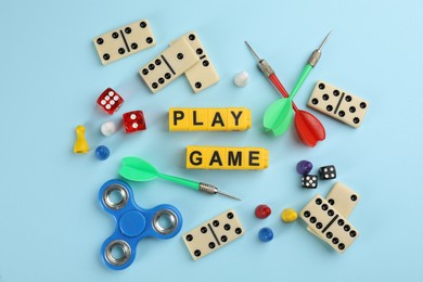 Photo of Flat lay composition of blocks with words Play Game on light blue background