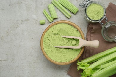 Photo of Natural celery powder and fresh stalks on grey table, flat lay. Space for text