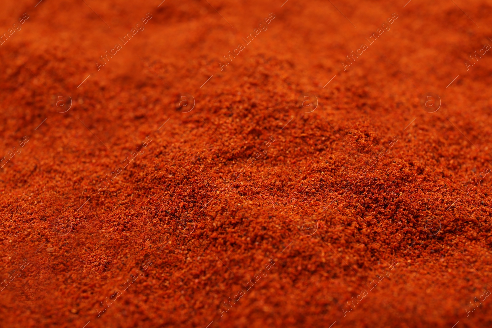 Photo of Aromatic paprika powder as background, closeup view