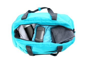 Sport bag with deodorant and clothes on white background, top view