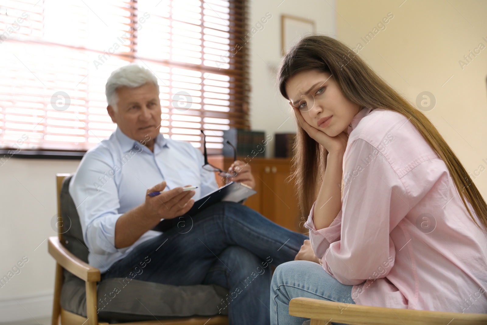 Photo of Professional psychotherapist working with patient in office