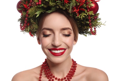 Photo of Beautiful young woman wearing Christmas wreath on white background, closeup