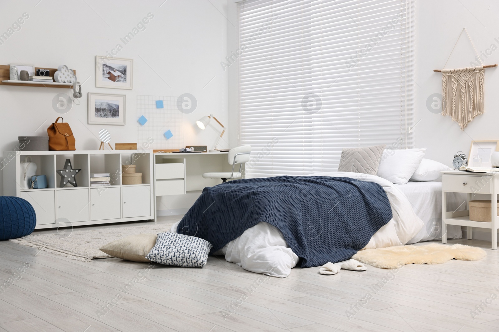 Photo of Bedroom interior with comfortable furniture, big window and white blinds